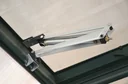 Automatic roof window opener for plastic greenhouses